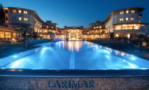 frontansicht_des_hotels_mit_beleuchtung_des_outdoor_pools_c_bernhard_bergmann_hotel_larimar